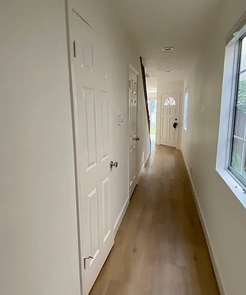 Downstairs hall with access to a powder room and one half bath.