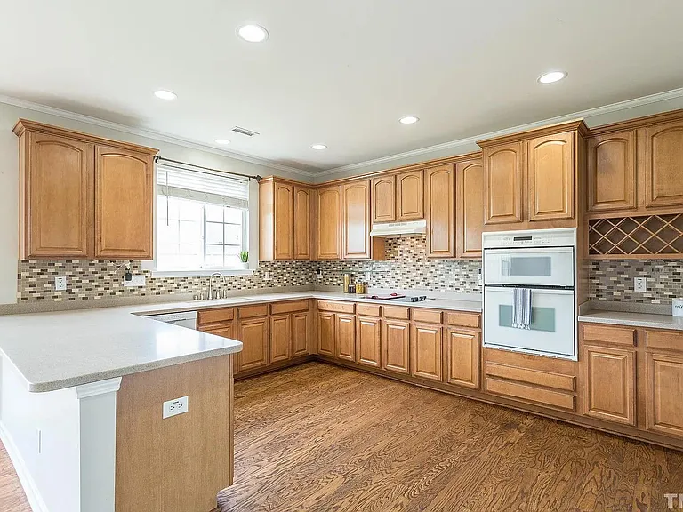 Kitchen with many cabinets, microwave, and oven.