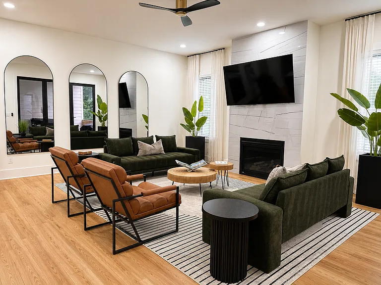 Beautifully designed living room with plush designer seating, fireplace, Smart TV, and direct access to outdoor dining on the deck. Perfect for movie nights, morning coffee, entertaining, and cozy group downtime that feels both elevated and inviting.