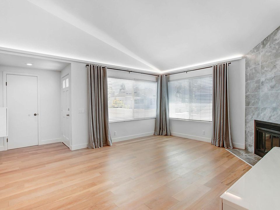 Front door, Coat Closet, Living Room, Fireplace with black fireglass, Cove lighting