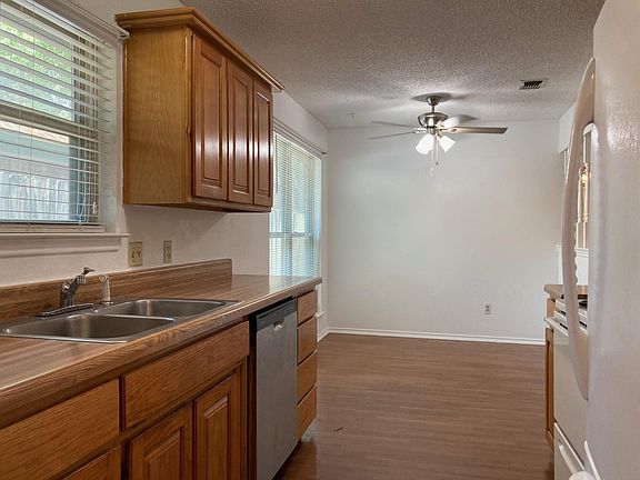 Kitchen opens into dining room and includes recently refinished wooden cabinets.
