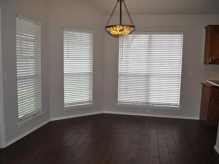 Kitchen dining with wall of windows to back yard