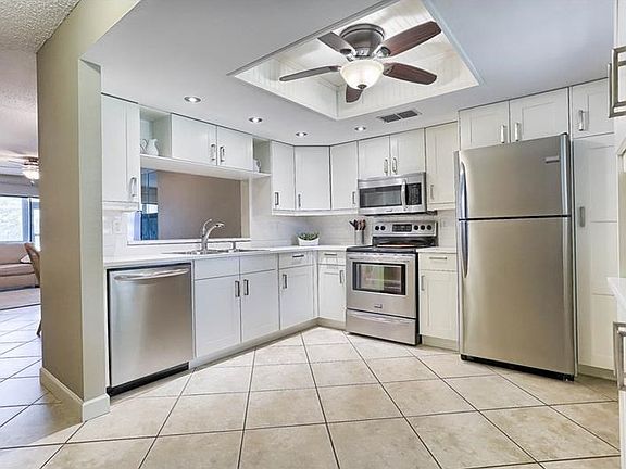 Tastefully updated kitchen with new cabinets, quartz counted top, stainless steel appliances, new ce