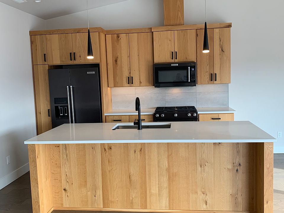 Open floor plan with natural light complemented by overhead and pendant lighting. Plenty of storage in kitchen, with island built for dining + additional dining area. Additional coffee bar and storage adjacent to the kitchen.