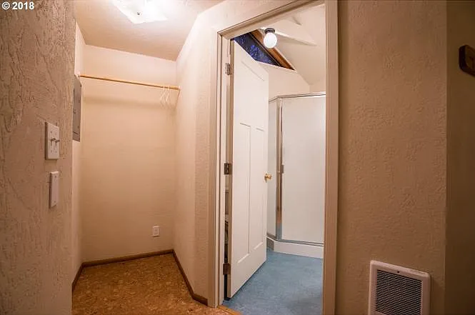 If you were to walk in the front door four steps then turn to the right, this is the view you'd see. This is the "closet" space and the entrance to the bathroom.
