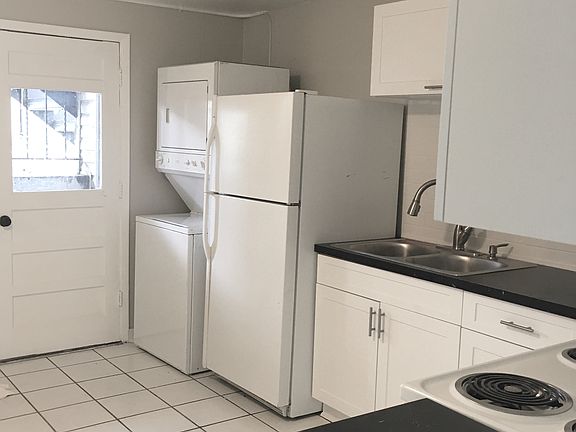 washer and dryer in unit, contemporary kitchen, and back patio access