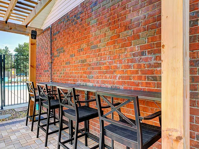 Take a seat and stay cool with shaded bar seating under the pergola, conveniently located right by the pool.