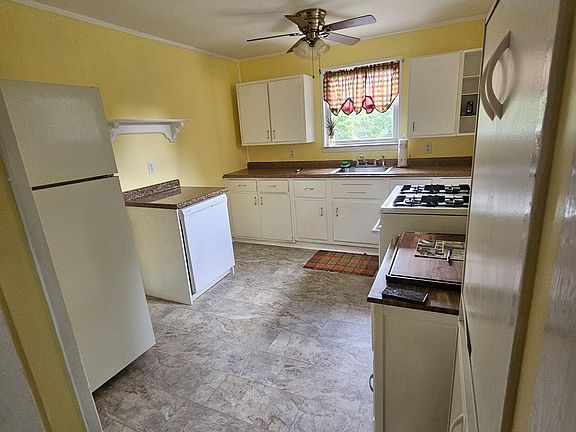 Kitchen with refrigerator, stove and dishwasher.