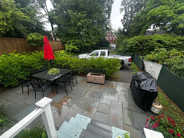 Stone patio and parking area. back yard.