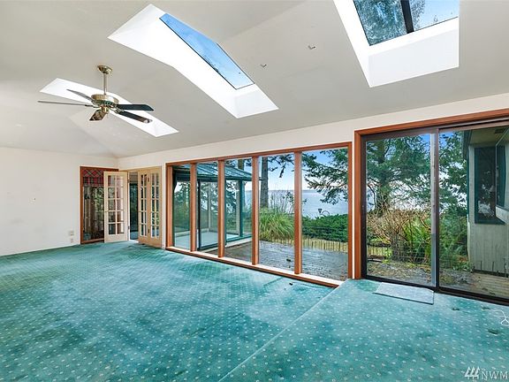 Living room with skylights and view to water.