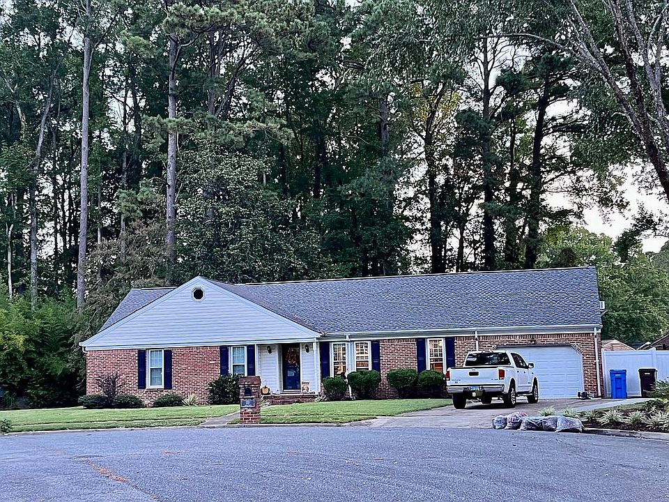 Home surrounded by beautiful trees with large fenced yard.
