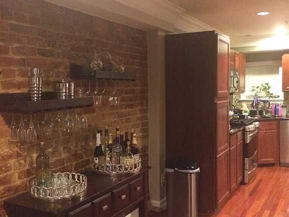 Exposed brick leading to kitchen