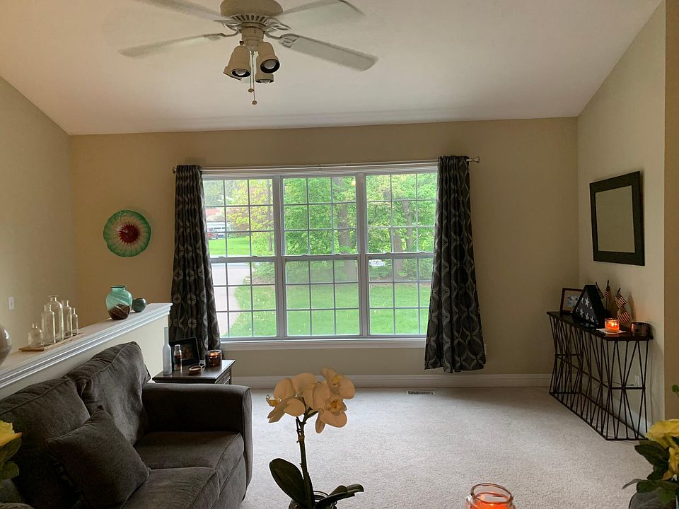 Living area with a beautiful view of green yard and trees.