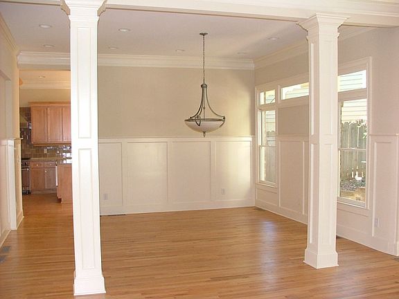 Custom Pillars and Hardwood Floors in this Formal Dining Room 
