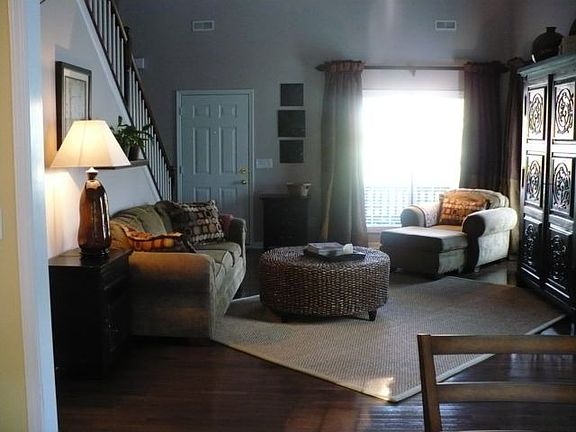 View of 2-story living room from kitchen/dining area.