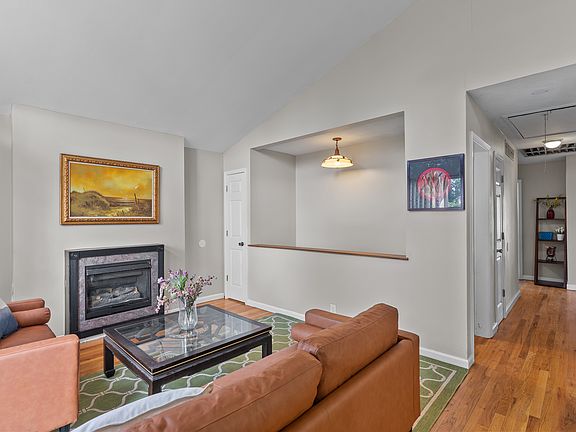 bright living room with big windows , leather sofa set