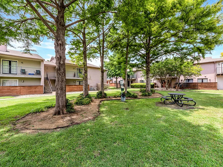 Beautifully landscaped courtyard with mature trees and green space.