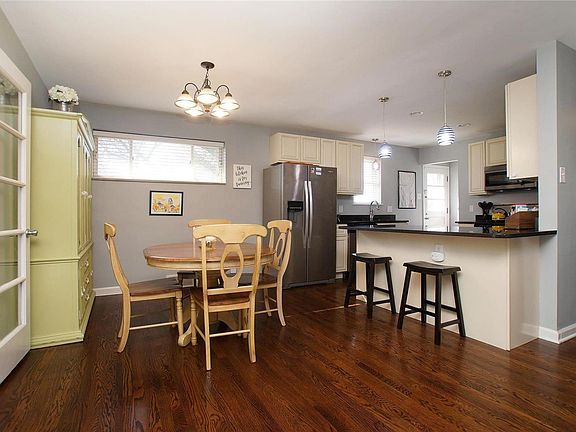 Light, Bright and Airy Dining and Kitchen area with gleaming wood floors and beautiful white cabinetry.
