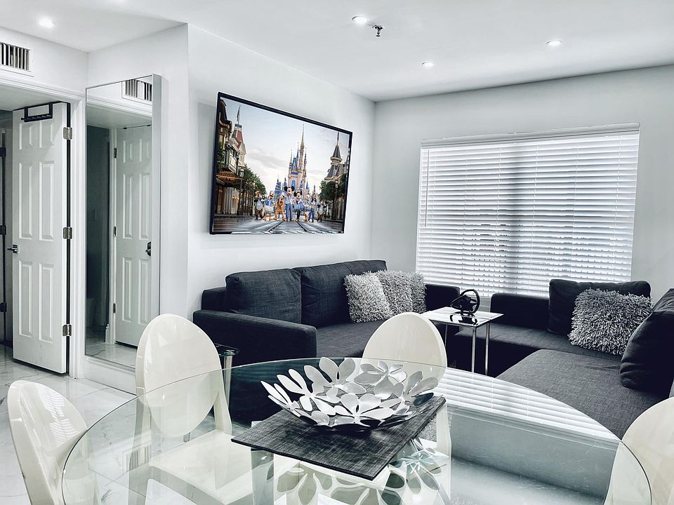 Dining & Living room with sofa group and 70 inch Smart TV. One sofa can be single bed