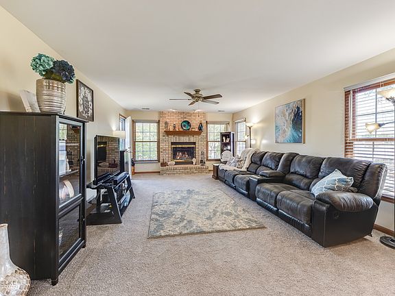 Spacious & open room w/brand new gorgeous carpeting, a gas fireplace & great natural light!