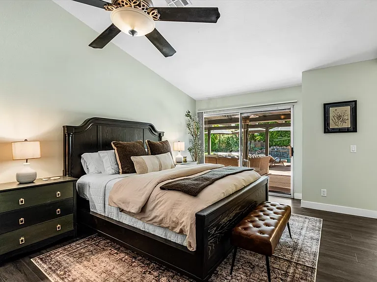 1st /Primary Bedroom with bathroom and walk in closet, TV - private access to patio/backyard
