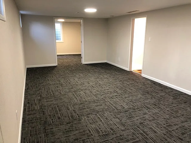Downstairs Family Room, newer carpet tiles, led lighting and insulation between floors make a very solid, quite area