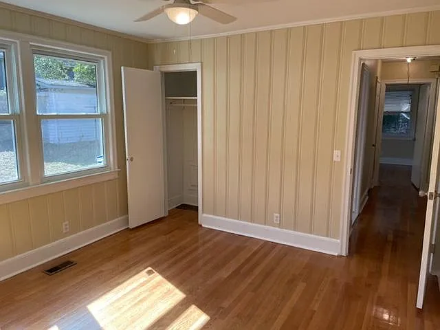 Third bedroom view of closet and paneled walls.