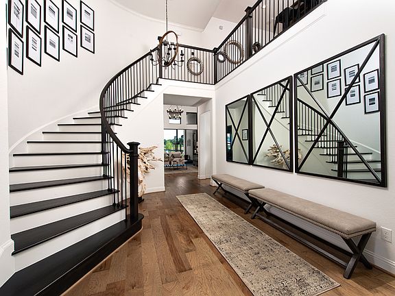 Two-story foyer with elegant curved staircase