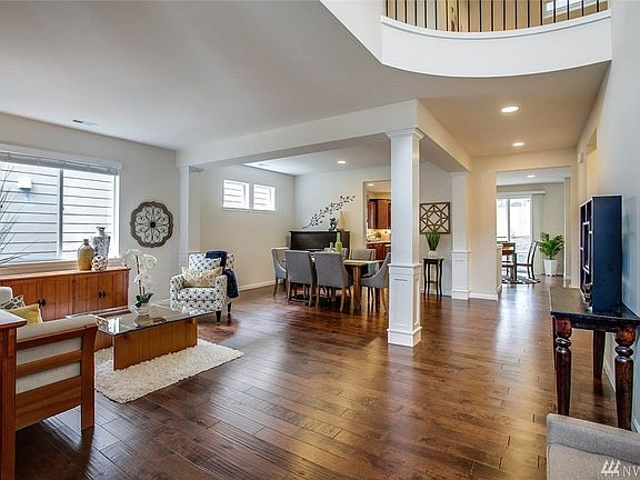 The stunning, soaring grand entry flows into the elegant living and dining rooms 