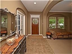 Tiled entry opens to a formal dining room or living room.