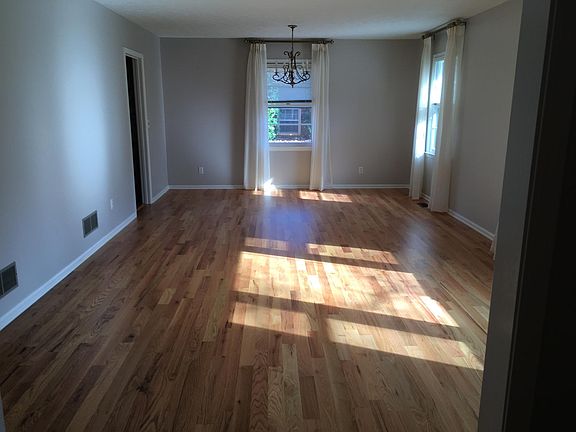 Formal Living Room/Dining Room. New hardwood floors. Paint color: Sherwin Williams Popular Gray. The doorway to the left leads to the kitchen.