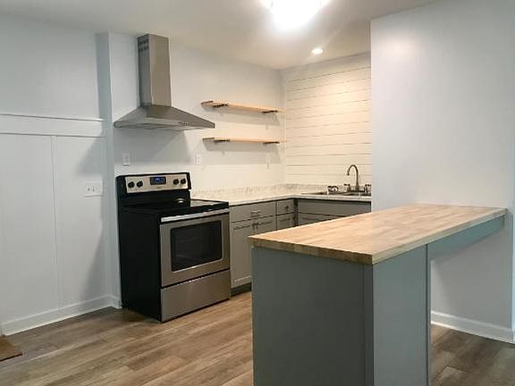 Butcher block peninsula with seating.