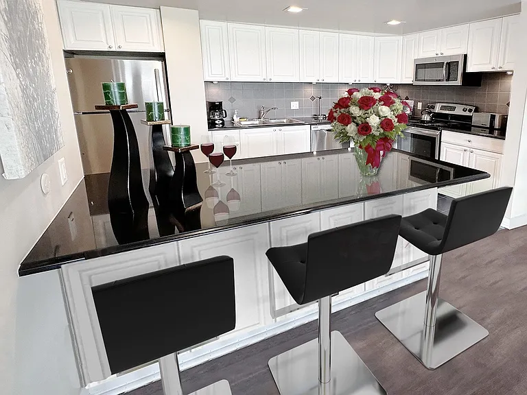 KITCHEN WITH BLACK GRANITE AND STAINLESS APPLIANCES