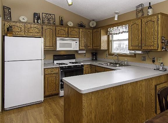 Oak cabinets, wood floors and an open plan to the dining area.