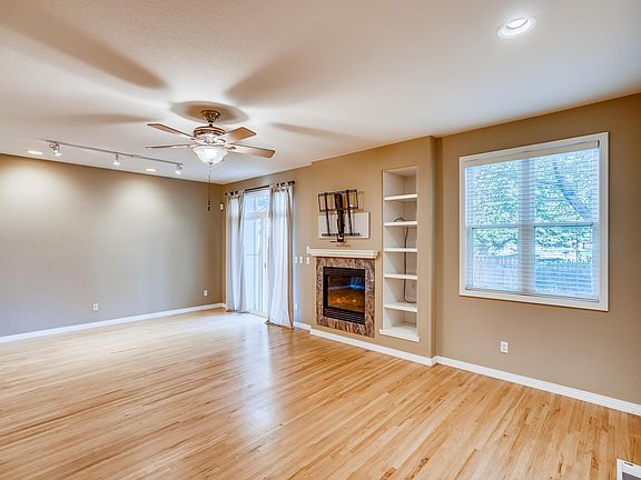 Open living and dining room area with a Mantle Mount over the fireplace for your TV