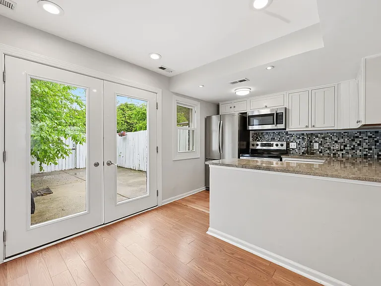Bright and Updated Kitchen with Breakfast Bar and Stainless Steel Appliances
