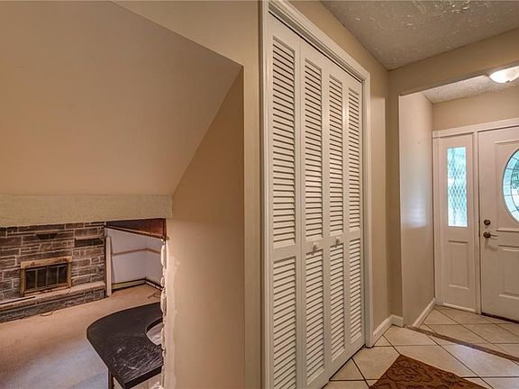 Oversize Front Closet for all your coats, stairs will take you down to the living area equipped with a Wood Burning Fireplace