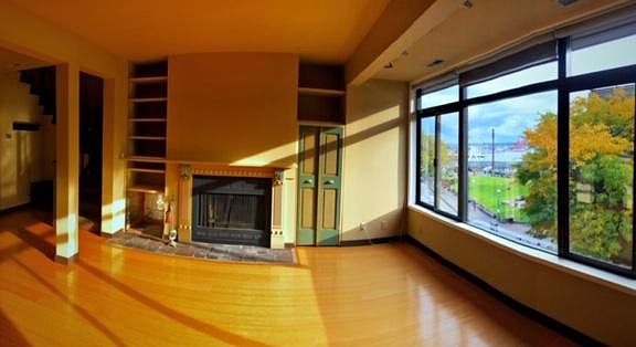 Living room with view toward Victor Steinbrueck park, The Wheel, and Elliott Bay