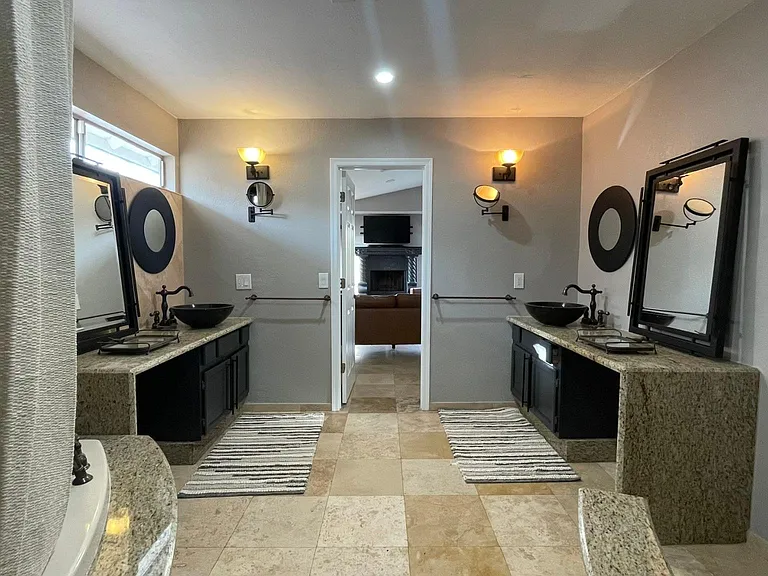 FURNISHED. Master bathroom, with two separate vanities, large bathtub.