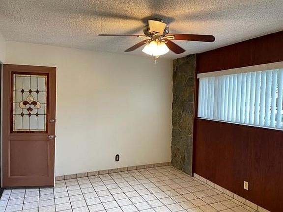 Kitchenette with door to side yard and laundry room.