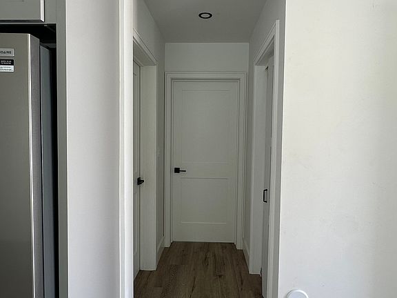 Downstairs Hallway to Bedroom 1, Washer Room, & Bathroom 1