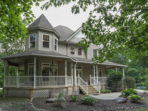 Relaxing wrap around porch is perfect for watching the seasons change!