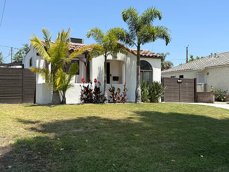 Front of house with a covered entry porch and a long private driveway with an automatic remote-controlled gate.