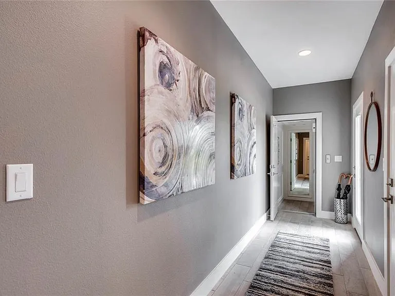 Welcoming private entry foyer with convenient garage access through the first door on the right.