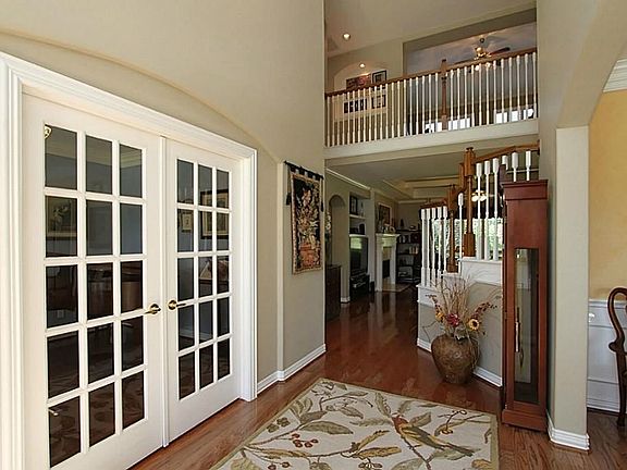 Foyer: Another view showing the openness. Notice the rich wood floors. Triple crown moulding surroun