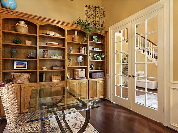 Home office located off the entry and away from the family living area, has built-in book cases and beautiful French doors for privacy.