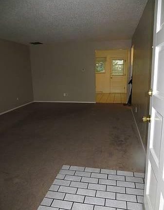 Entry way showing living room before new paint