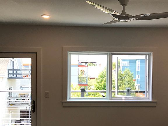 Living room with large windows and door to private balcony.