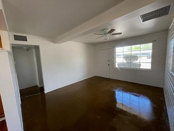 Roomy living room with sealed floors, fresh paint, new fan, AC/Heat pump.
