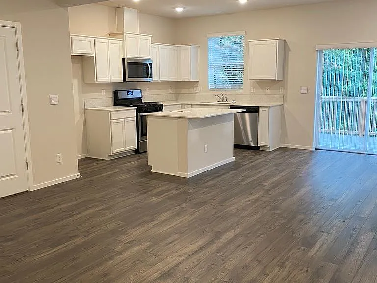 Open concept kitchen with living room and dining.